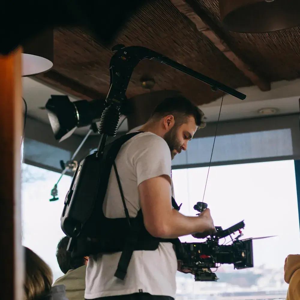 Camera operator on an Easyrig at the window