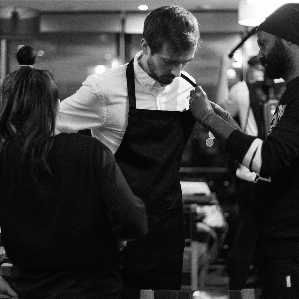 Make-up touch-up for the waiter before the take