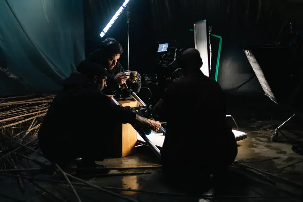 Film crew at work on the APAV set, camera and lights around the young actor