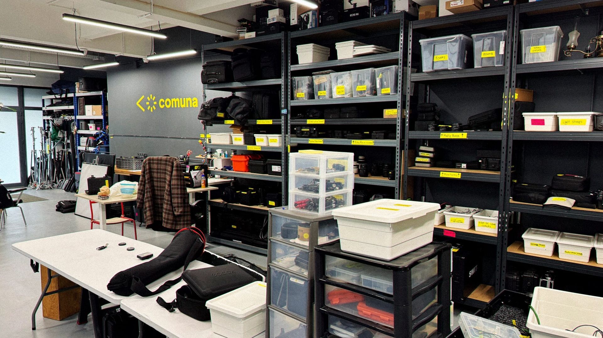 Shelves of cameras, lenses and lighting at Comuna Rental House, Lisbon