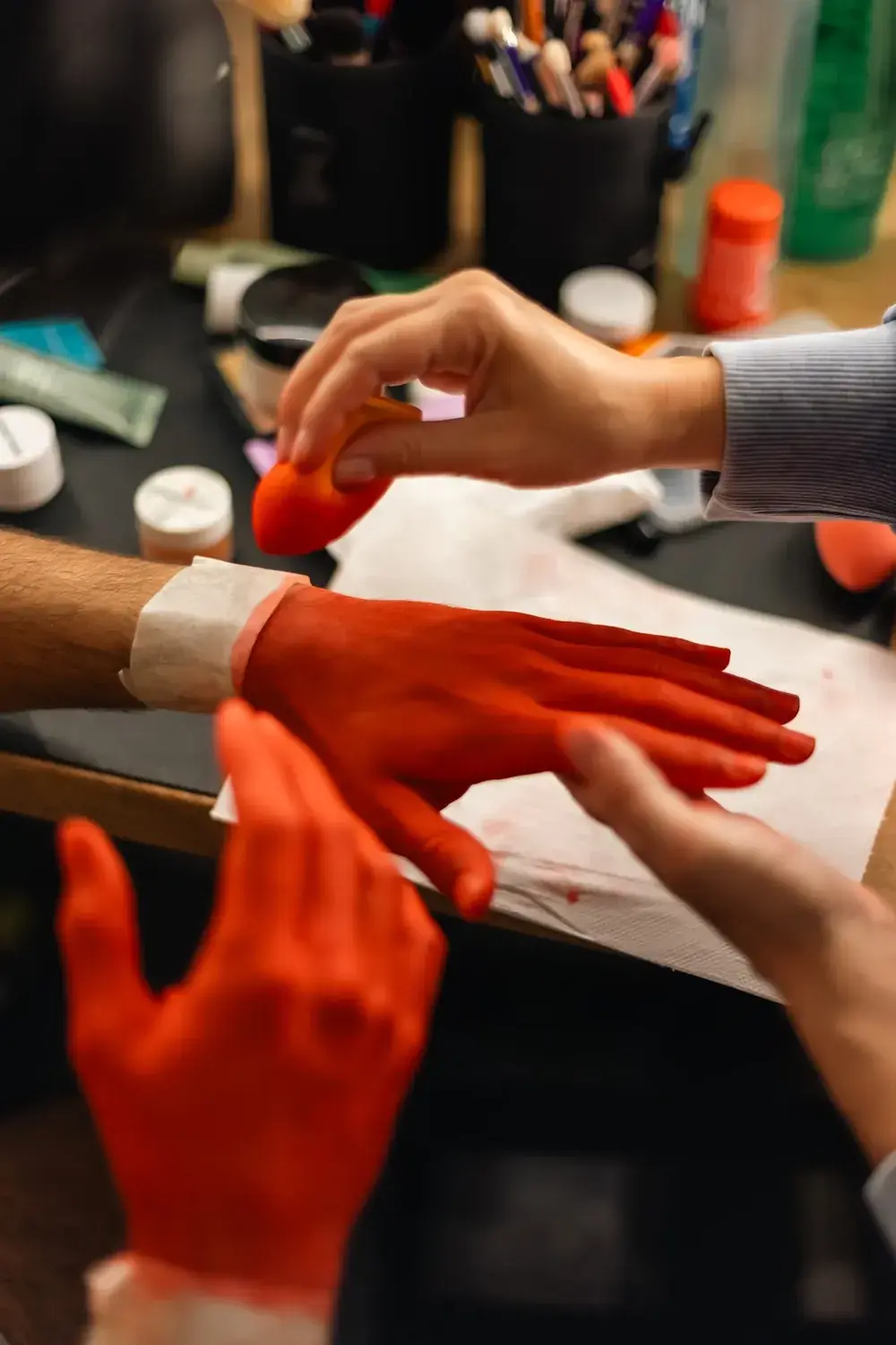 Painting the dancer's hands red on set