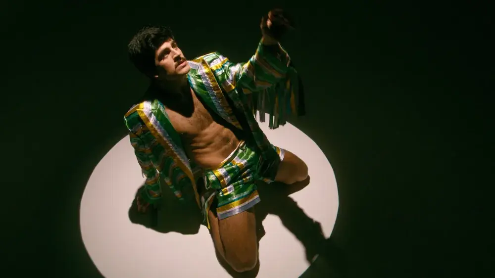 Dancer Tomás Fernandes in a single spotlight, still from Transformation