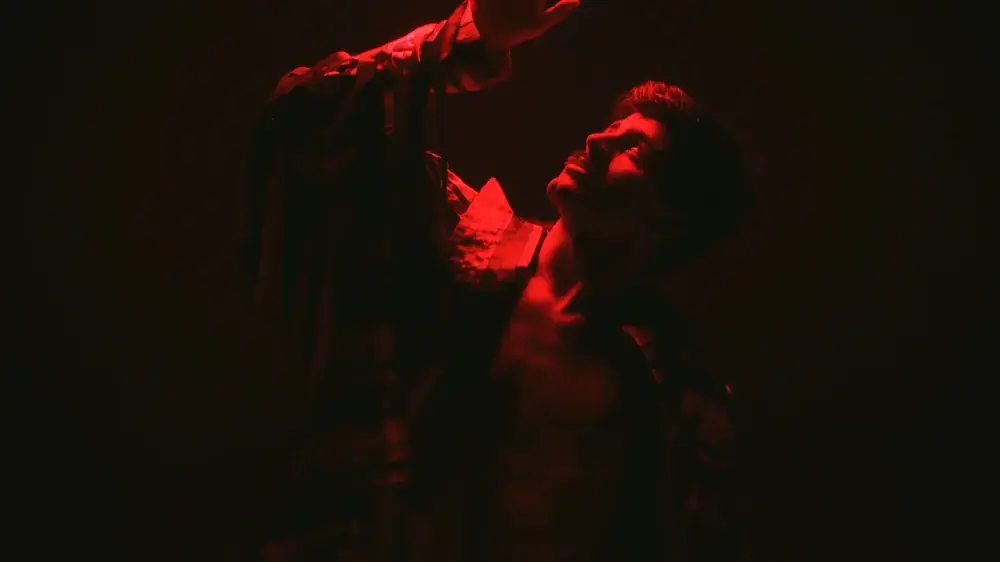 Red-lit portrait of dancer Tomás Fernandes